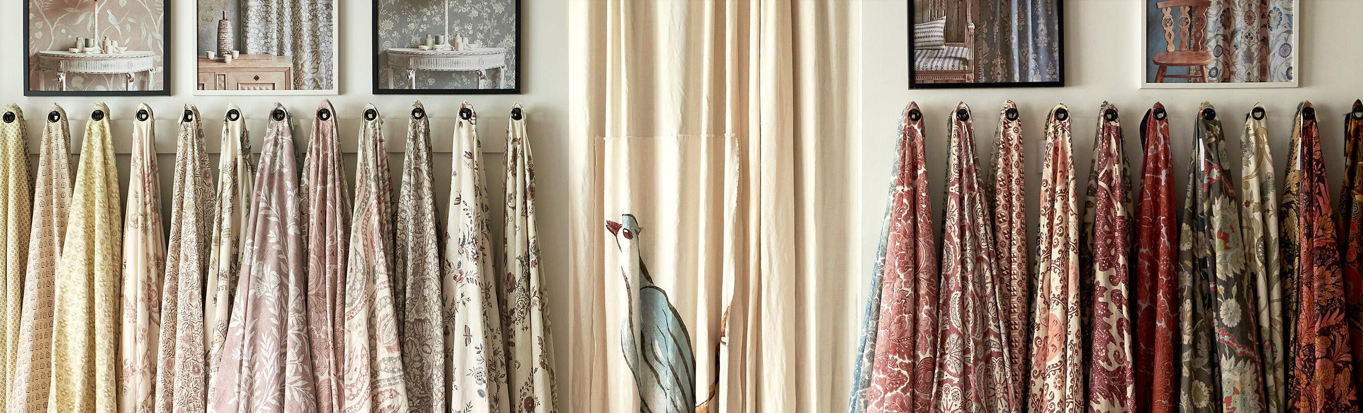 <p>Patterned Lewis & Wood fabrics hanging in the London showroom</p>