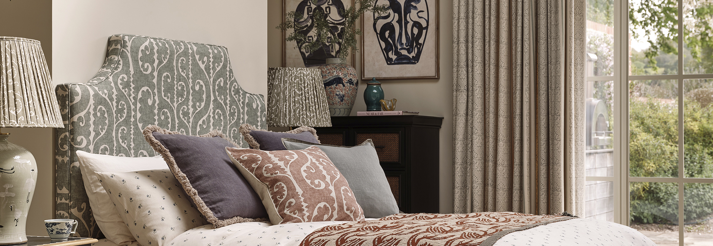 lewis and wood with oka collaboration totem design headboard, cushion and lamps in bedroom